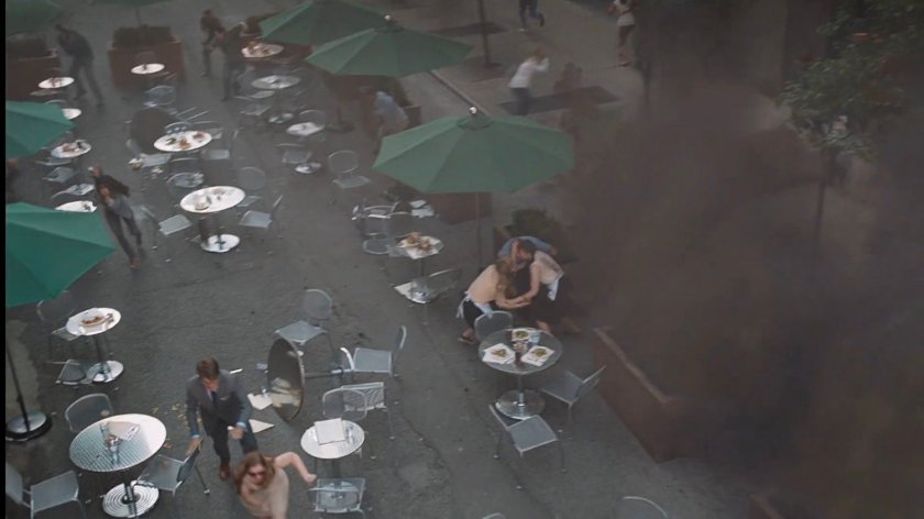 High angle view of people fleeing an outdoor cafe.