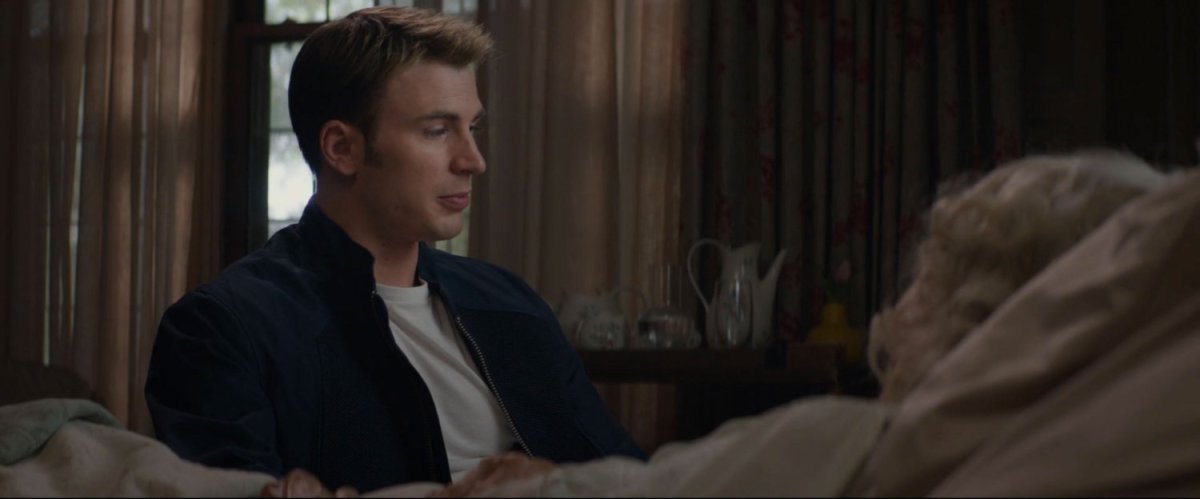 Steve sits with an elderly Peggy Carter in her bedroom.
