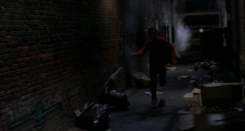Peter Parker running through dark alley.